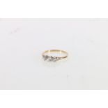 18ct gold and platinum diamond three stone ring, the central diamond approximately 0.25ct flanked by