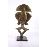 Gabon, Kota reliquary figure, the wood sheathed with brass, punched detail, wooden stand, 52cm.