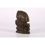 Small 20th century African carving of a boy holding a cat, 15.5cm high