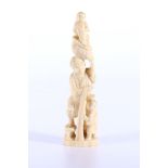 Japanese ivory carving of a fisherman holding a boy, with a fish and a basket on his head, another