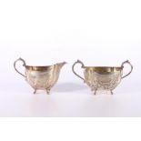 19th Century Indian silver part teaset of sugar and milk jug of lobed spherical form with scroll