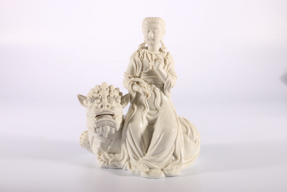 Mid 20th century Chinese blanc de Chine figure of Quan Yin seated on a lion dog, 20cm x 18cm