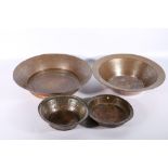 Four various Jordanian copper metal food bowls, two with inscribed calligraphy to the rims,