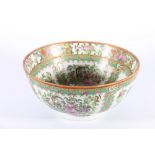 Chinese Canton famille rose bowl decorated with birds, butterflies and flowers reserved in a