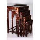 20th century Chinese nest of four hardwood tables, carved edge and pierced to the aprons with