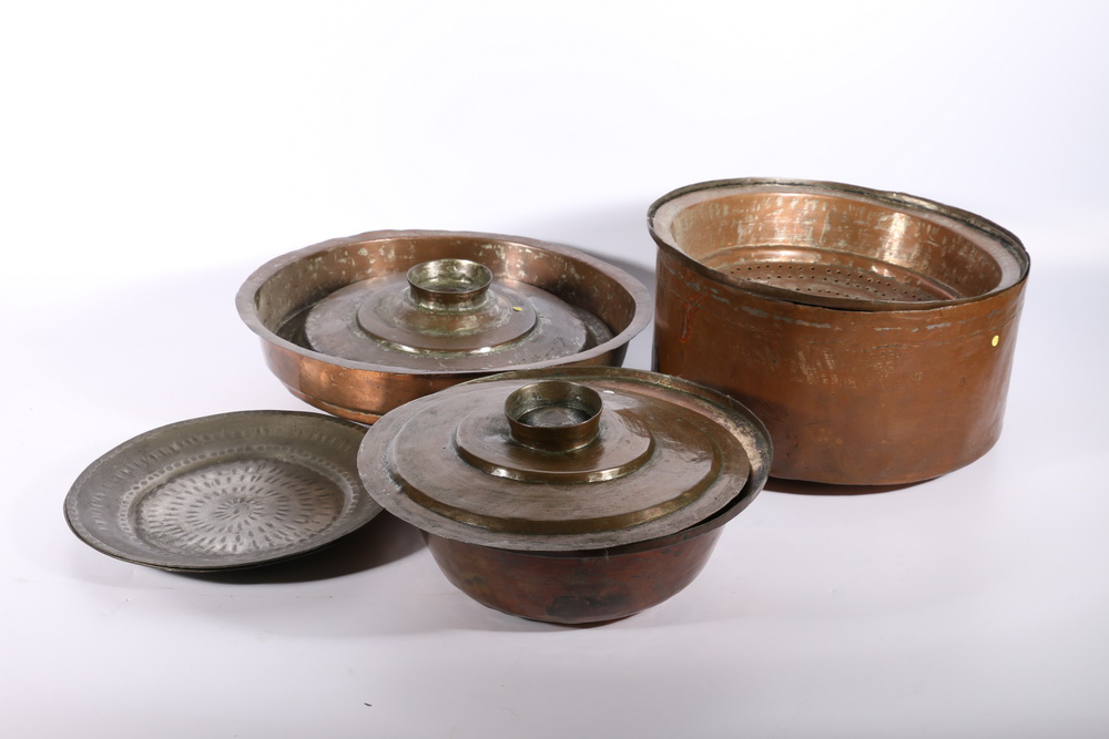 Group of 19th century Jordanian copper cooking dishes including three graduated pots and covers, one