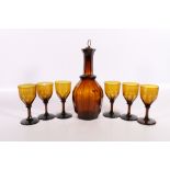 19th century brown amber glass decanter and six matching wine glasses, 29cm and 13cm tall