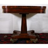 19th century rosewood and coromandel crossbanded fold over games table raised on fielded obelisk