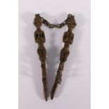 Pair of African bronze slender fertility/ritual staffs or figures united with a chain possibly