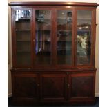 19th century mahogany library bookcase, the moulded cornice above four glazed panel doors on base