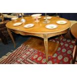 Continental inlaid oval dining table with additional leaf, with gilt metal mounts, on scroll support