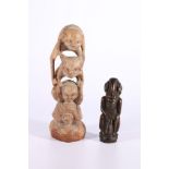 Dyak carved wooden fertility figure, 14cm and another wooden carving of three creatures morphing