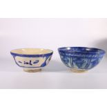 Two Iranian blue and white bowls, one with simple calligraphic decoration, 20cm, the second with