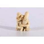 Late 19th or early 20th Century carved ivory netsuke of Fukurukuju with a boy by his side, both