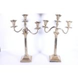 Pair of silver plated candelabra raised on Corinthian column stems and stepped bases by WH&S, 58cm