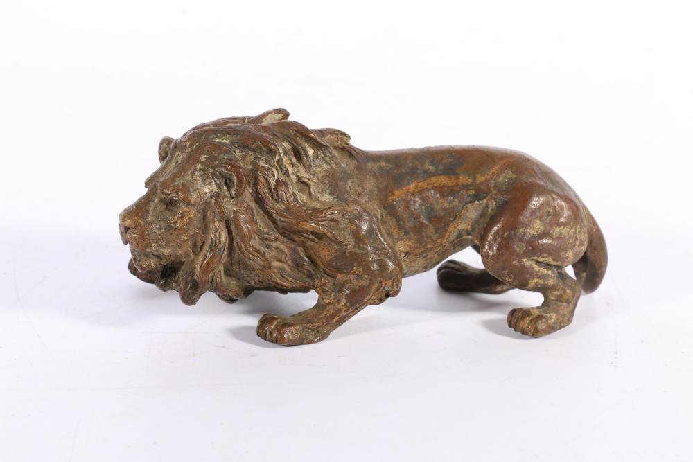 19th century cast bronze model of lion, 16cm long