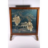 Japanese embroidered panel mounted as a wood framed fire screen, the panel depicting two figures,