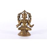 Early 20th Century gilt brass figure of Lakshmi seated on a lotus throne, two of the four arms