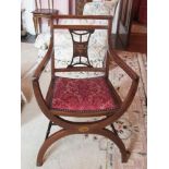Edwardian mahogany elbow chair, inlaid stringing and back splat, on arched front supports.