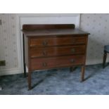 Edwardian mahogany ledge back chest of three drawers, inlaid stringing on square supports.