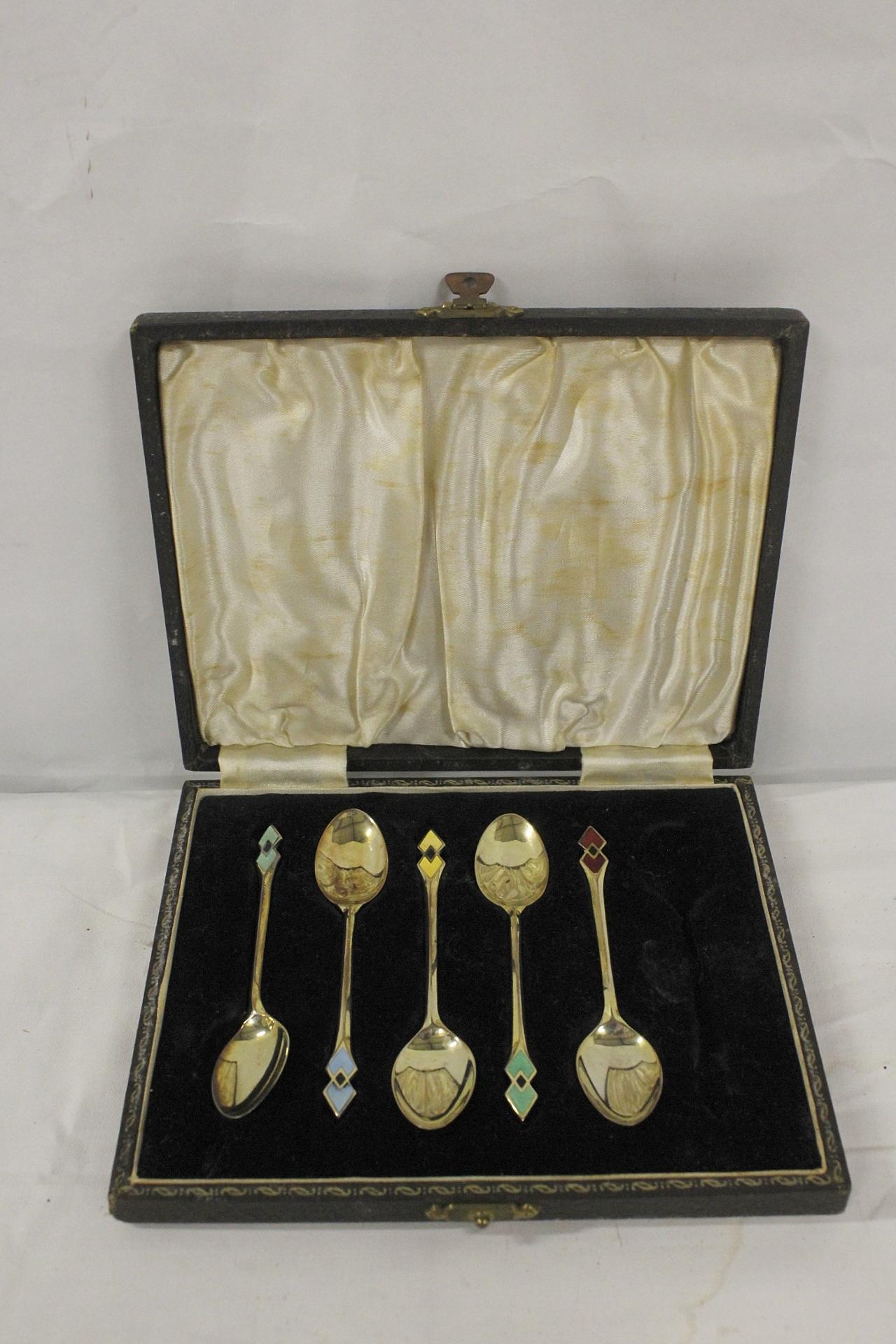 Set of five silver and enamel coffee spoons, cased for six