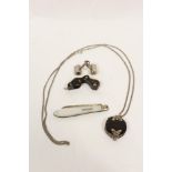 Magnifying glass in silver, tortoiseshell, another with silver mounts, a necklet and a fruit knife.