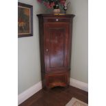 Georgian crossbanded mahogany corner cupboard on later cupboard base.