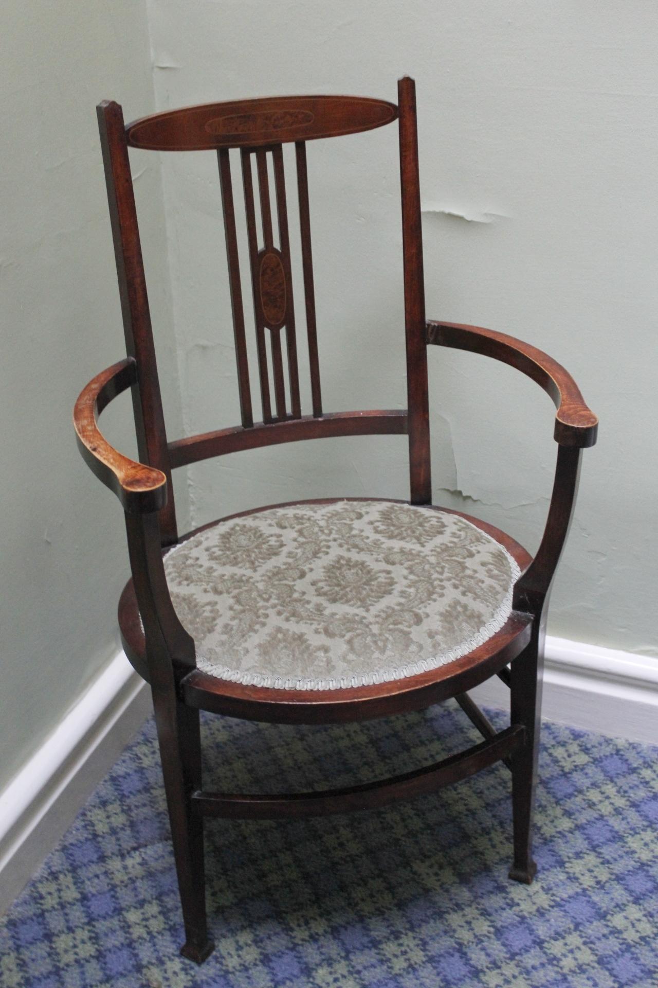 Edwardian mahogany elbow chair, oval seat and inlaid stringing.