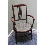 Edwardian mahogany elbow chair, oval seat and inlaid stringing.