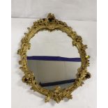 Oval wall mirror in gilt foliate frame.