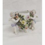 Sitzendorf porcelain sweetmeat bowl with putti supports and floral encrusted decoration