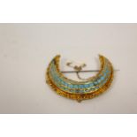 Indian gold crescent brooch with three rows of simulated turquoise