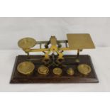Set of brass postal scales with weights to 16oz, plinth base, 32cms wide