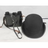 Bowler hat and a pair of binoculars, cased. (2)