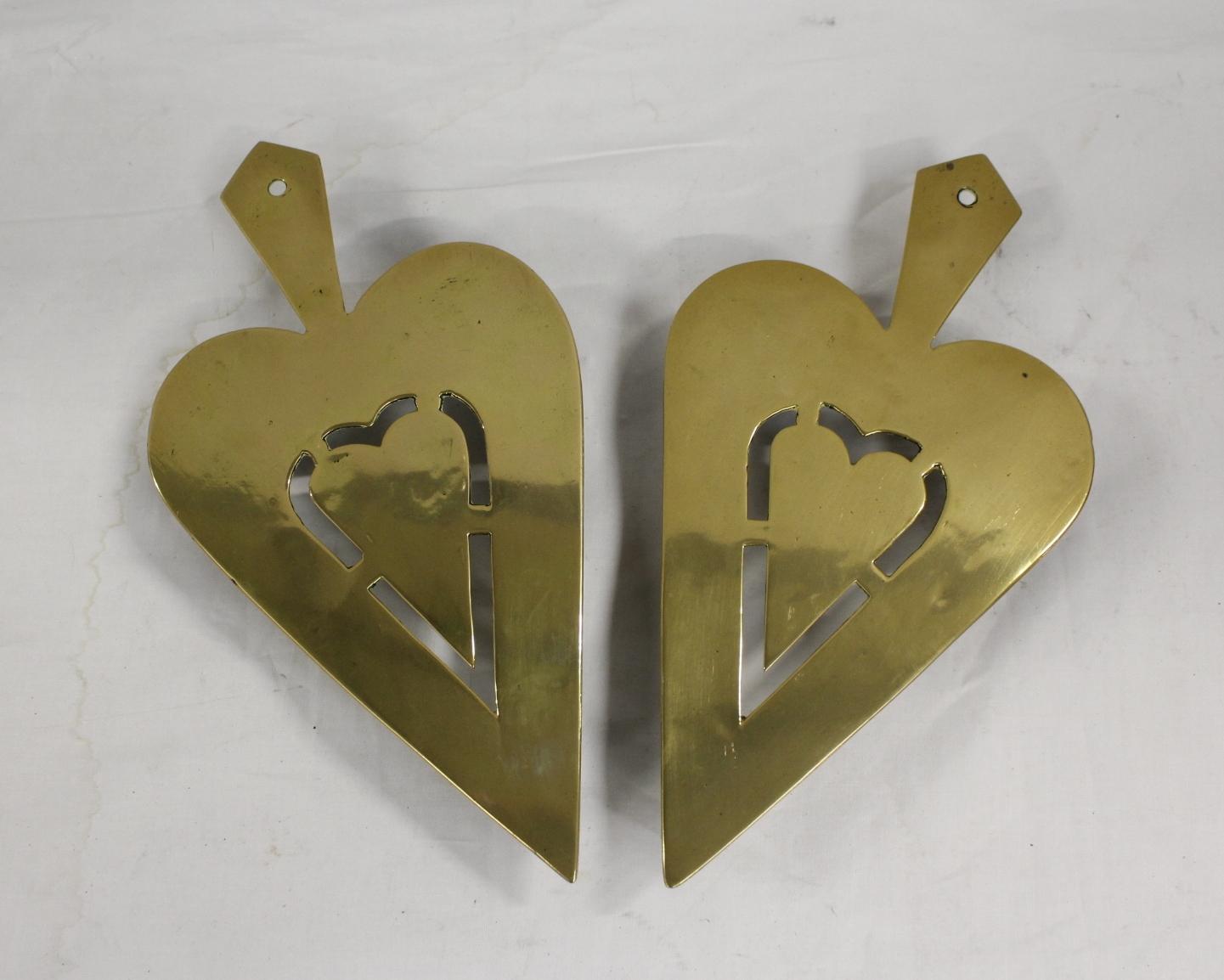 Pair of brass trivets, each of pierced spade shape and another. (3)