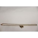 Gold necklet with watch key and flower charm. 11g
