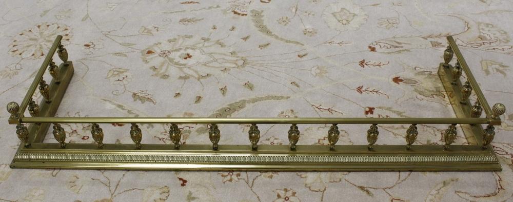 19th century brass fender with urn turned supports. 122cm internal width