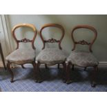 Set of three Victorian mahogany balloon back dining chairs, over upholstered seats and cabriole