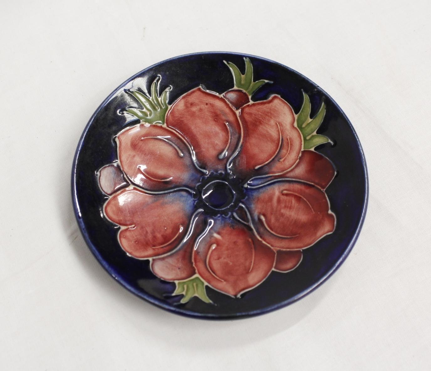 Moorcroft Pottery Anemone pattern circular pin dish, blue ground. 12cm