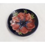 Moorcroft Pottery Anemone pattern circular pin dish, blue ground. 12cm