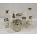 Cut glass toilet jar with silver embossed cover and seven other jars and covers. (8)