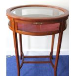 Oval mahogany vitrine table on square tapered splay supports and understretchers, 59cm wide.