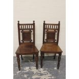 Pair of 19th century Reformed Gothic mahogany solid seat hall chairs.