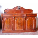 Victorian mahogany sideboard, the arched back panel mounted by floral finial, rectangular top over