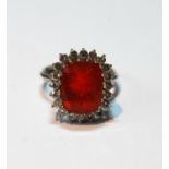 Fire opal and diamond ring, the opal of cushion shape, approximately 13mm x 10mm, surrounded by