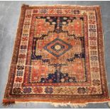 Caucasian rug with central medallion over blue ground, spandrels, and border, 115cm x 98cm.