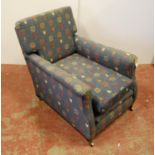 Edwardian low gentleman's armchair with loose cushioned back and seat, raised on square tapering