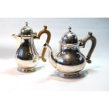 Silver teapot of pear shape, and a hot water pot, crested, by C.S. Harris & Sons, 1925/6, 22oz.