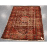 Malayeri rug with central flowerhead medallion over blue ground, all over floral design, spandrels