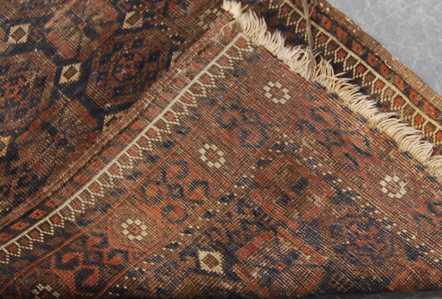 Eastern rug with two rows of eleven rosettes over faded brown ground, and triple border, 142cm x - Image 4 of 4
